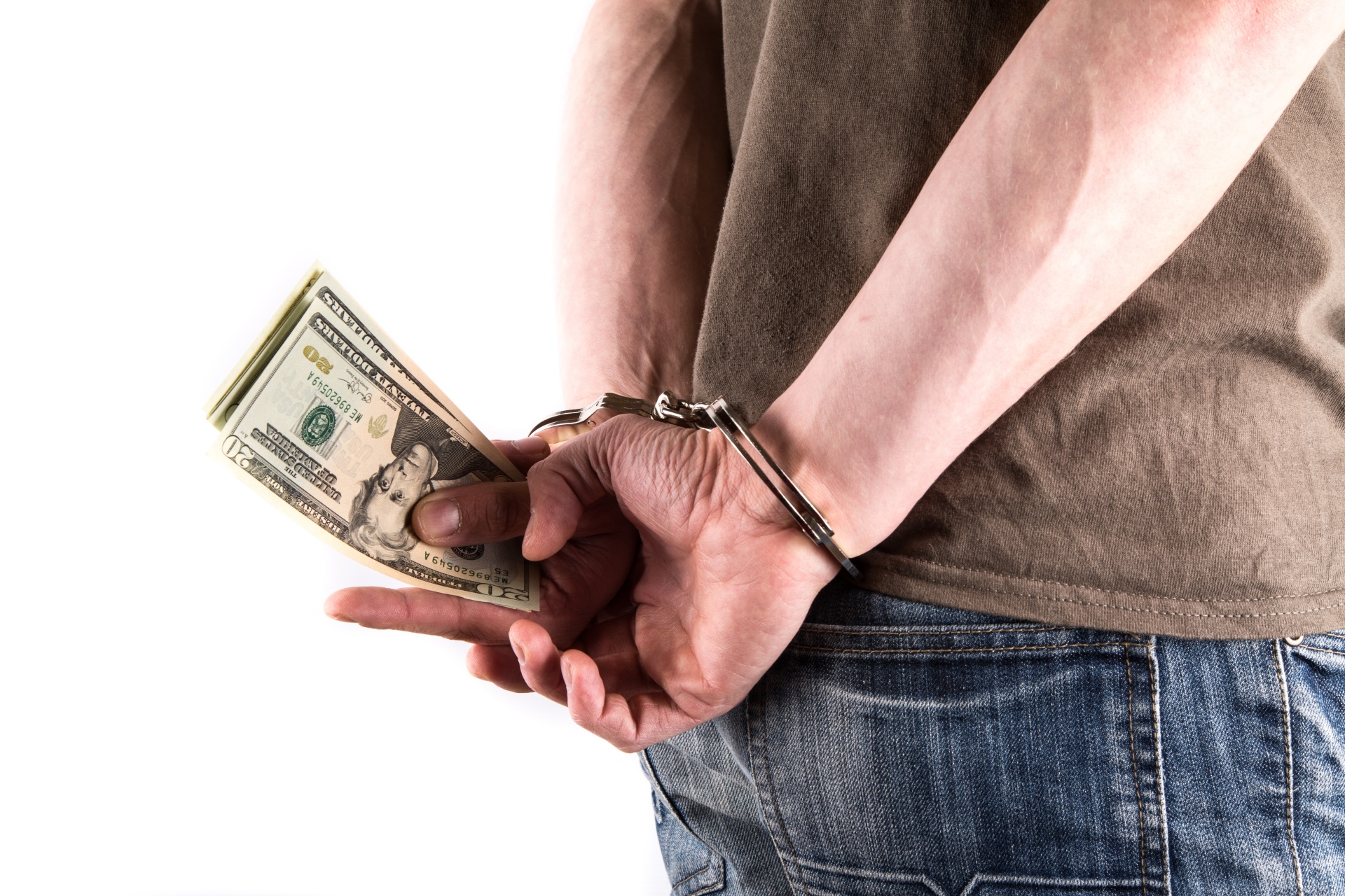 Man in handcuffs holding money